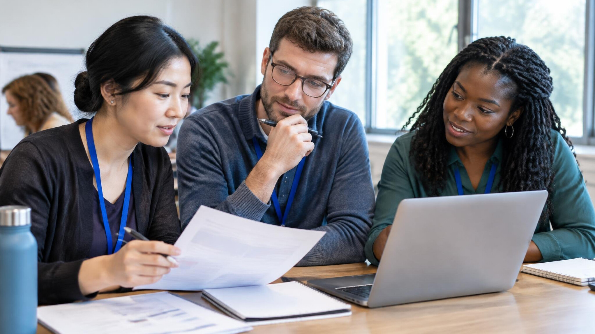 Group of adults discussing notes during a workshop session